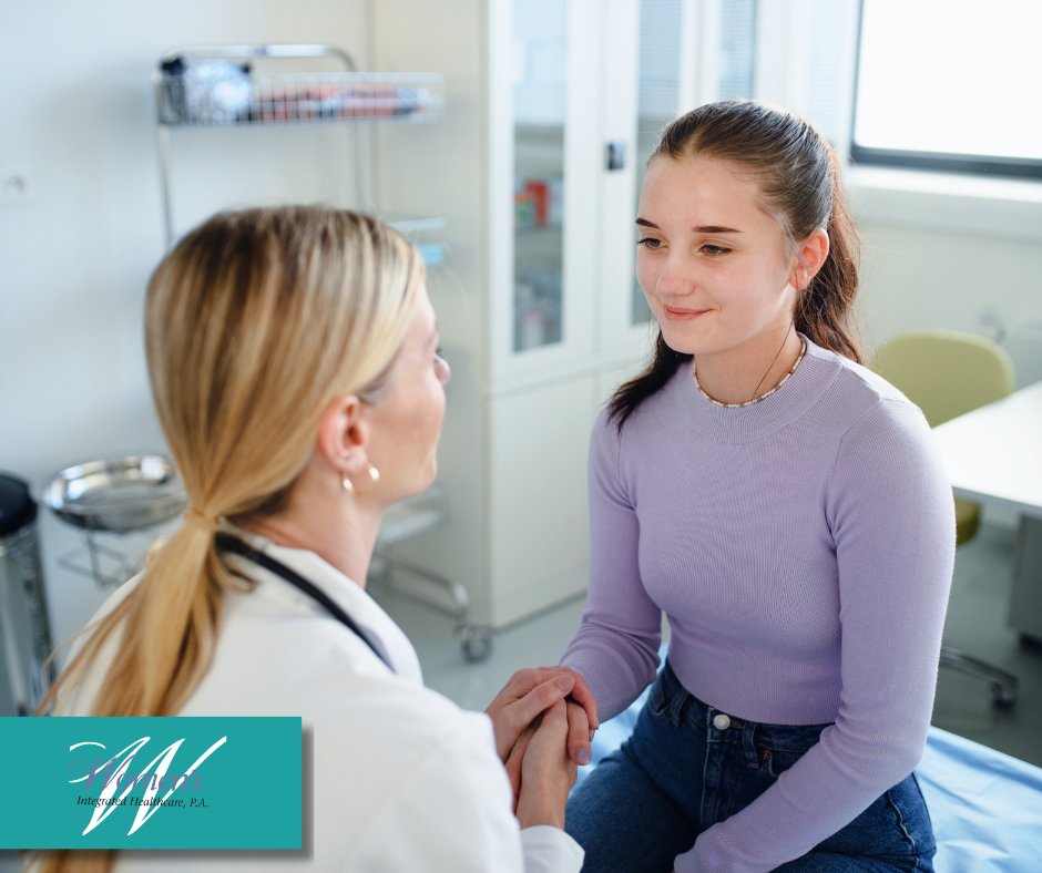 A teenage girl consulting with her doctor getting support and reassurance.