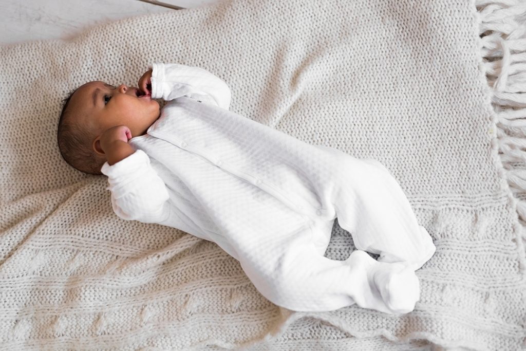 baby in white pajamas
