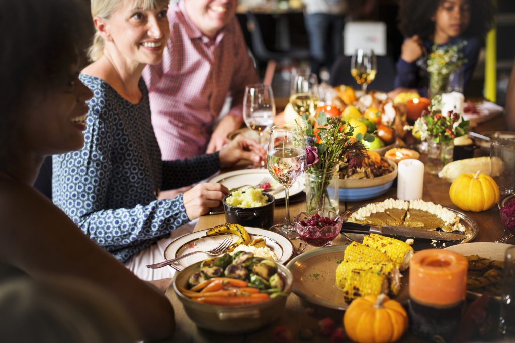 A table of family and friends celebrating Thanksgiving.