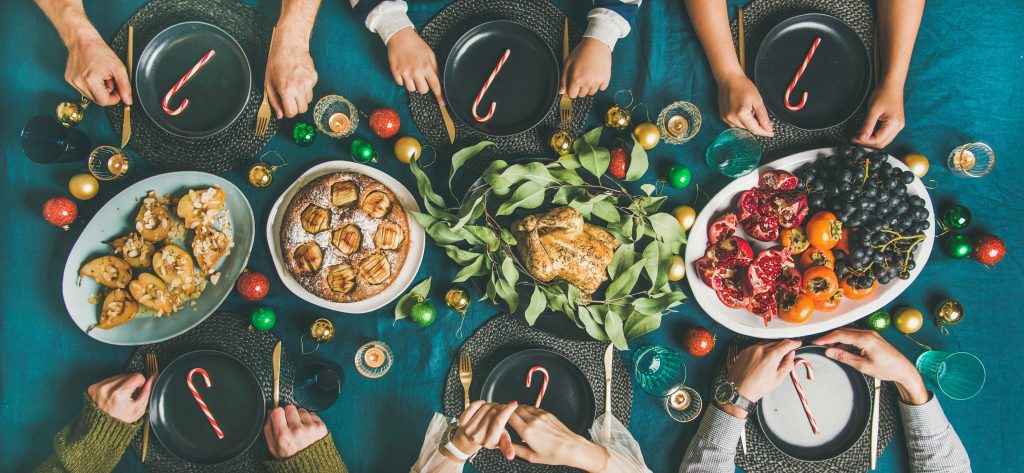 Overhead view of family and friends sharing a holiday meal.